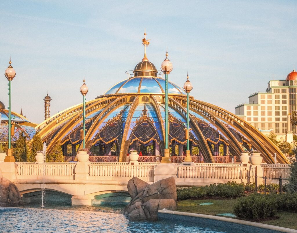 Colorful domed building by water and bridge