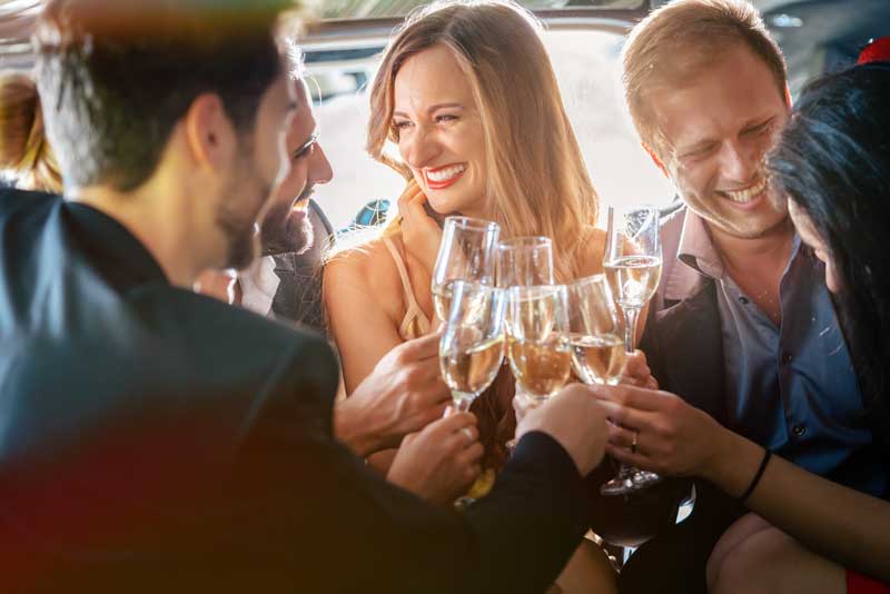 Friends toasting with champagne, smiling and laughing.