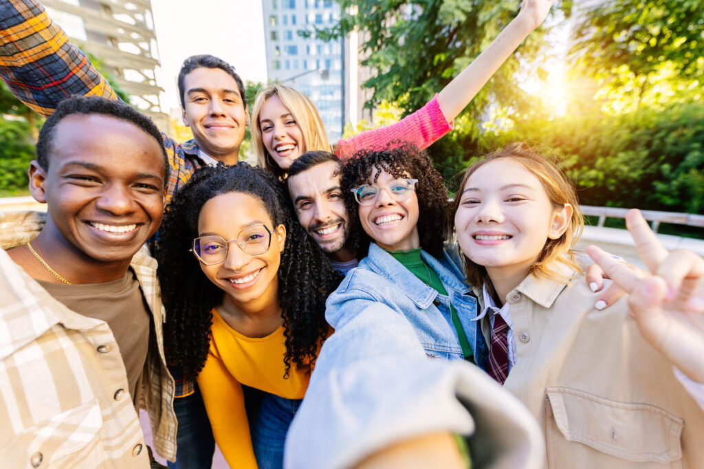 Diverse group of friends smiling outdoors.