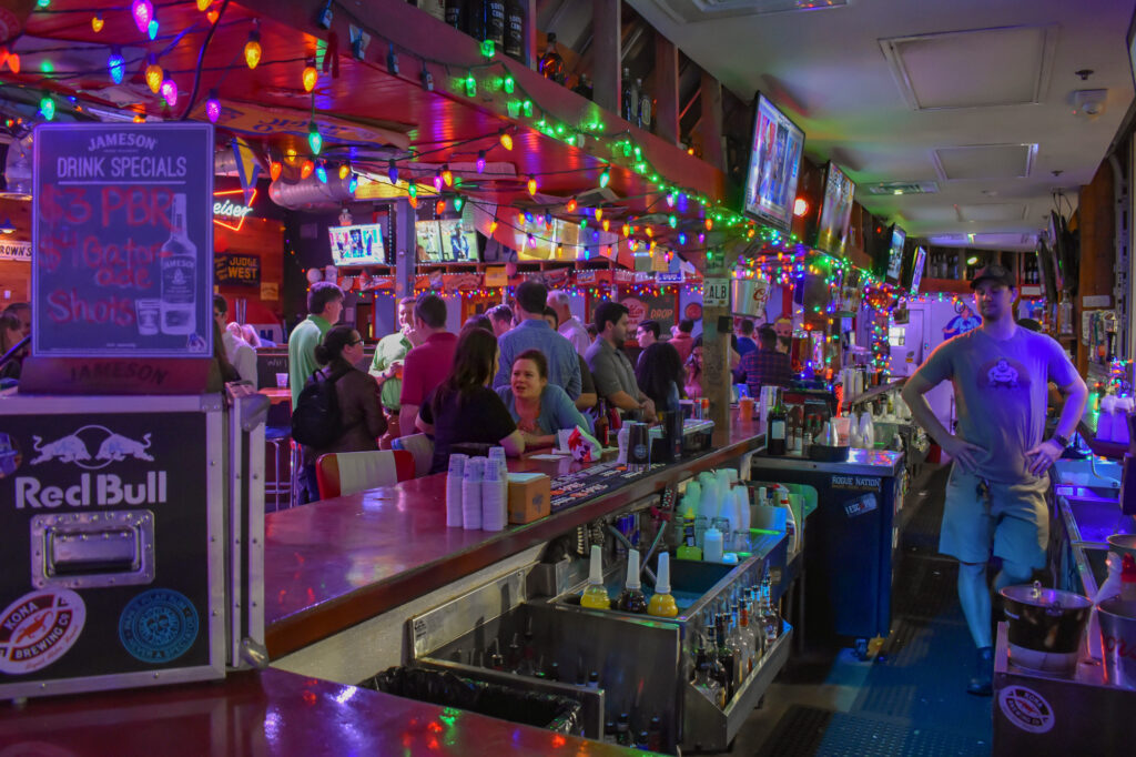 Lively bar scene with colorful lights and patrons.