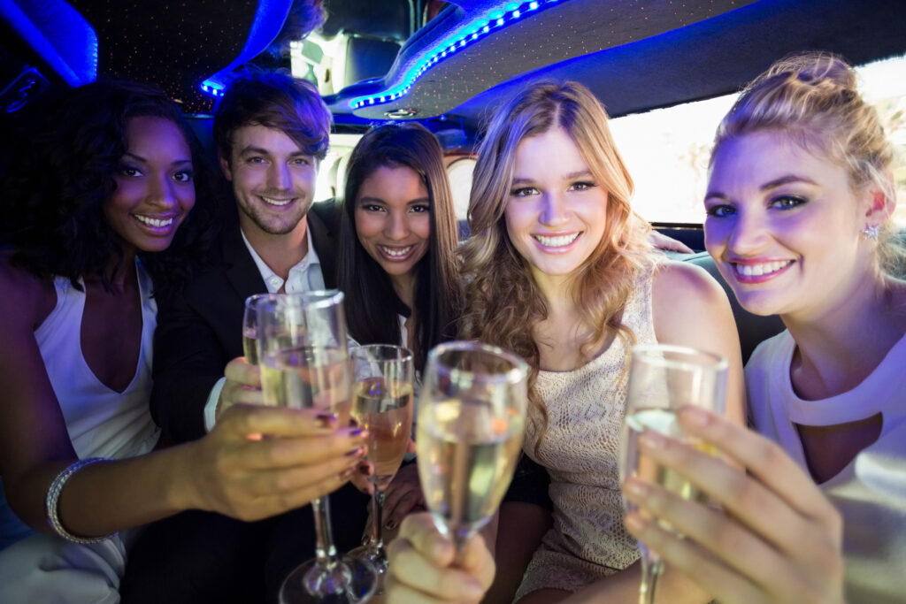 Friends celebrating with champagne in a limousine